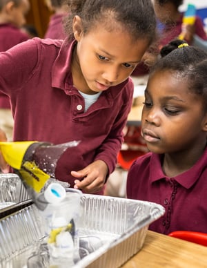 Two kindergarteners work together to engineer